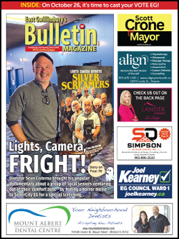 A man is smiling in front of a magazine cover that says “Bulletin Magazine". AI generated content